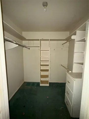 a view of storage and utility room with racks on the wall