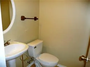 a white toilet sitting next to a bathroom sink