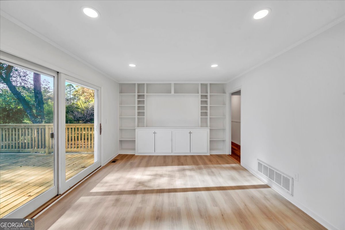 1806 Knox Street Dublin, GA 31021 - Photo 13 of 48 a view of empty room with wooden floor and fan