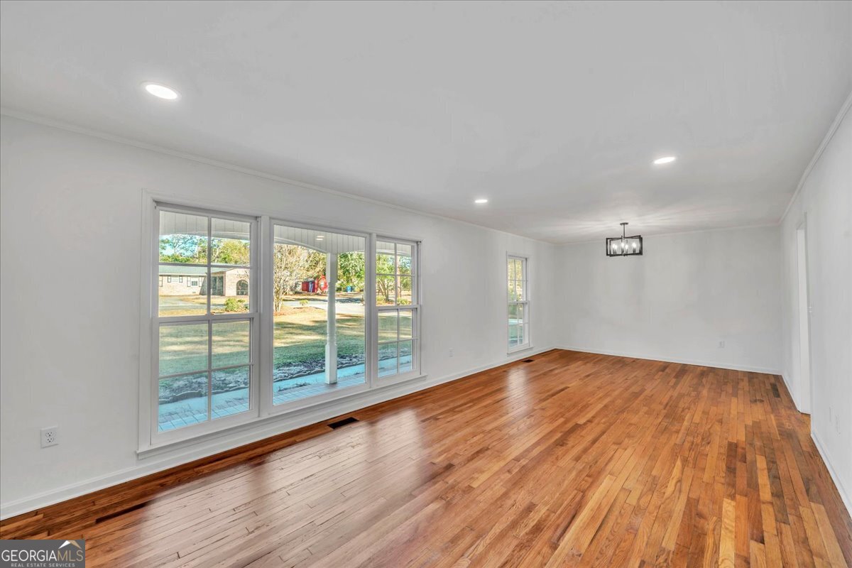 1806 Knox Street Dublin, GA 31021 - Photo 15 of 48 wooden floor in an empty room with a window