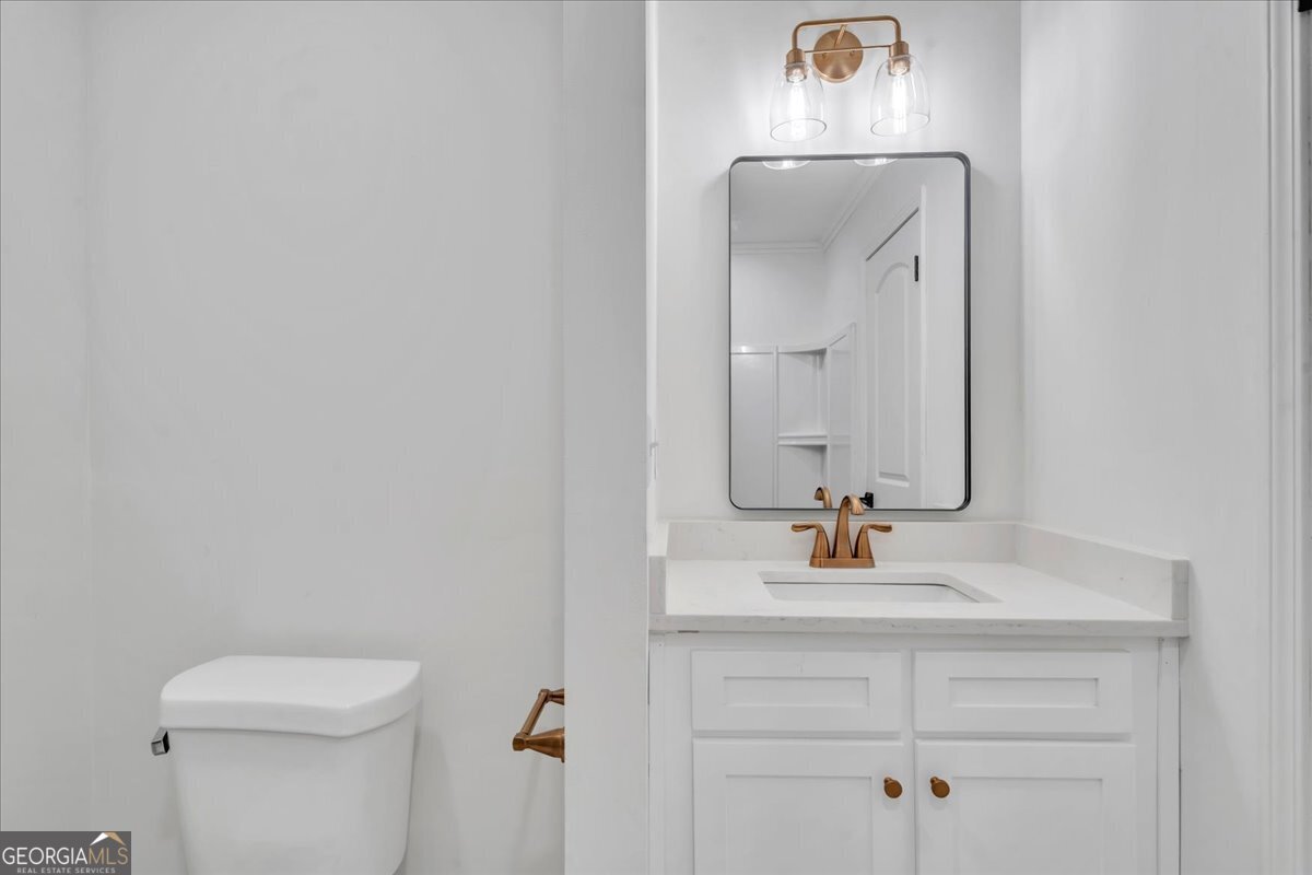 1806 Knox Street Dublin, GA 31021 - Photo 25 of 48 a bathroom with a sink vanity and a mirror