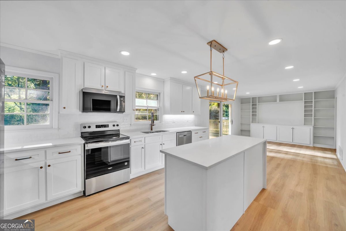1806 Knox Street Dublin, GA 31021 - Photo 3 of 48 a kitchen with stainless steel appliances a stove sink microwave and cabinets