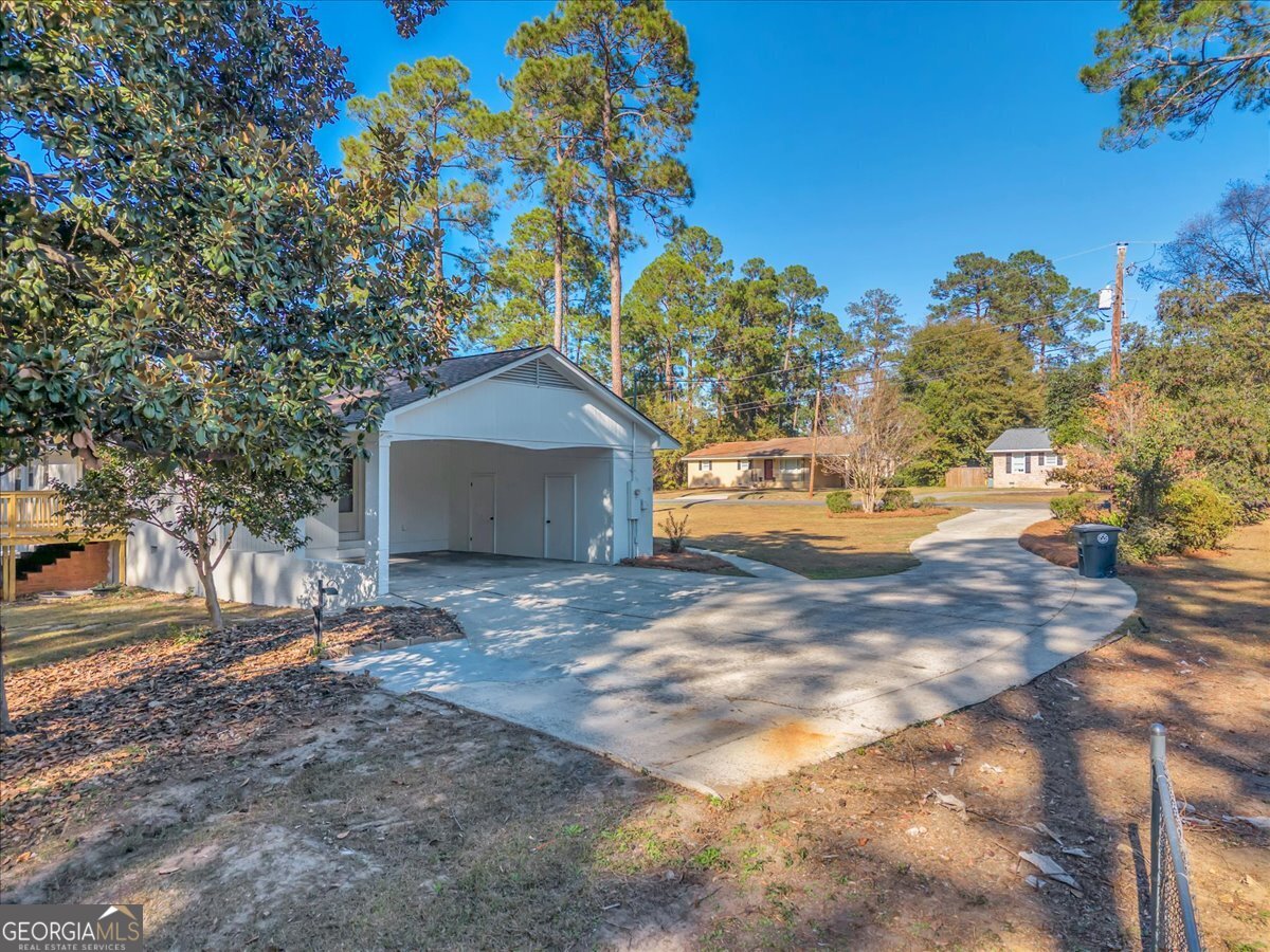 1806 Knox Street Dublin, GA 31021 - Photo 31 of 48 a backyard of a house with outdoor seating and trees