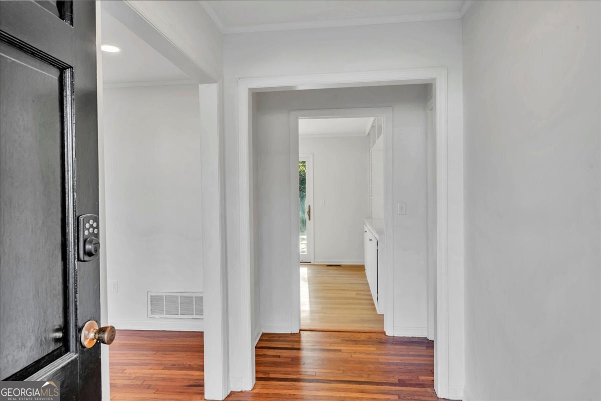 1806 Knox Street Dublin, GA 31021 - Photo 41 of 48 a view of a hallway with wooden floor and staircase