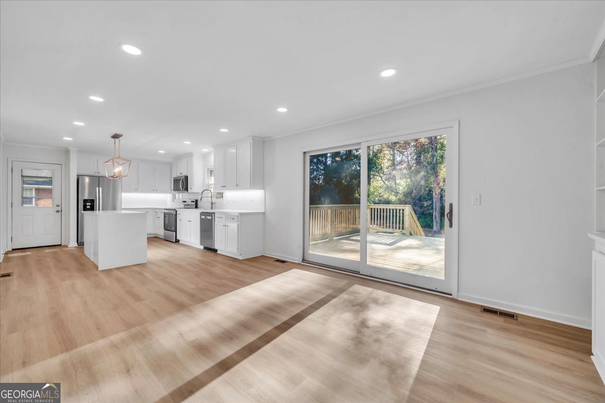 1806 Knox Street Dublin, GA 31021 - Photo 6 of 48 a large white bedroom with a large bed and a large window