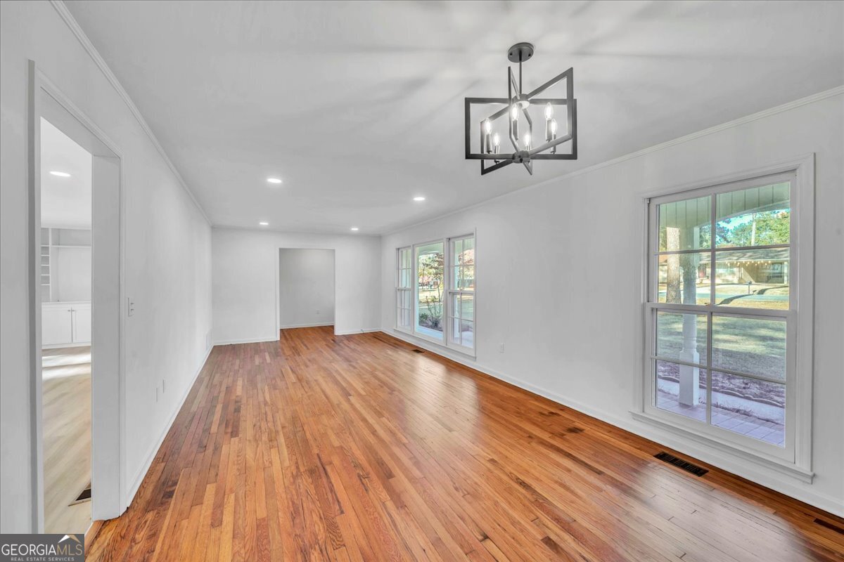 1806 Knox Street Dublin, GA 31021 - Photo 10 of 48 a view of empty room with wooden floor and fan