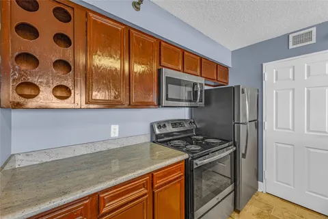 a kitchen with stainless steel appliances granite countertop a stove and a microwave