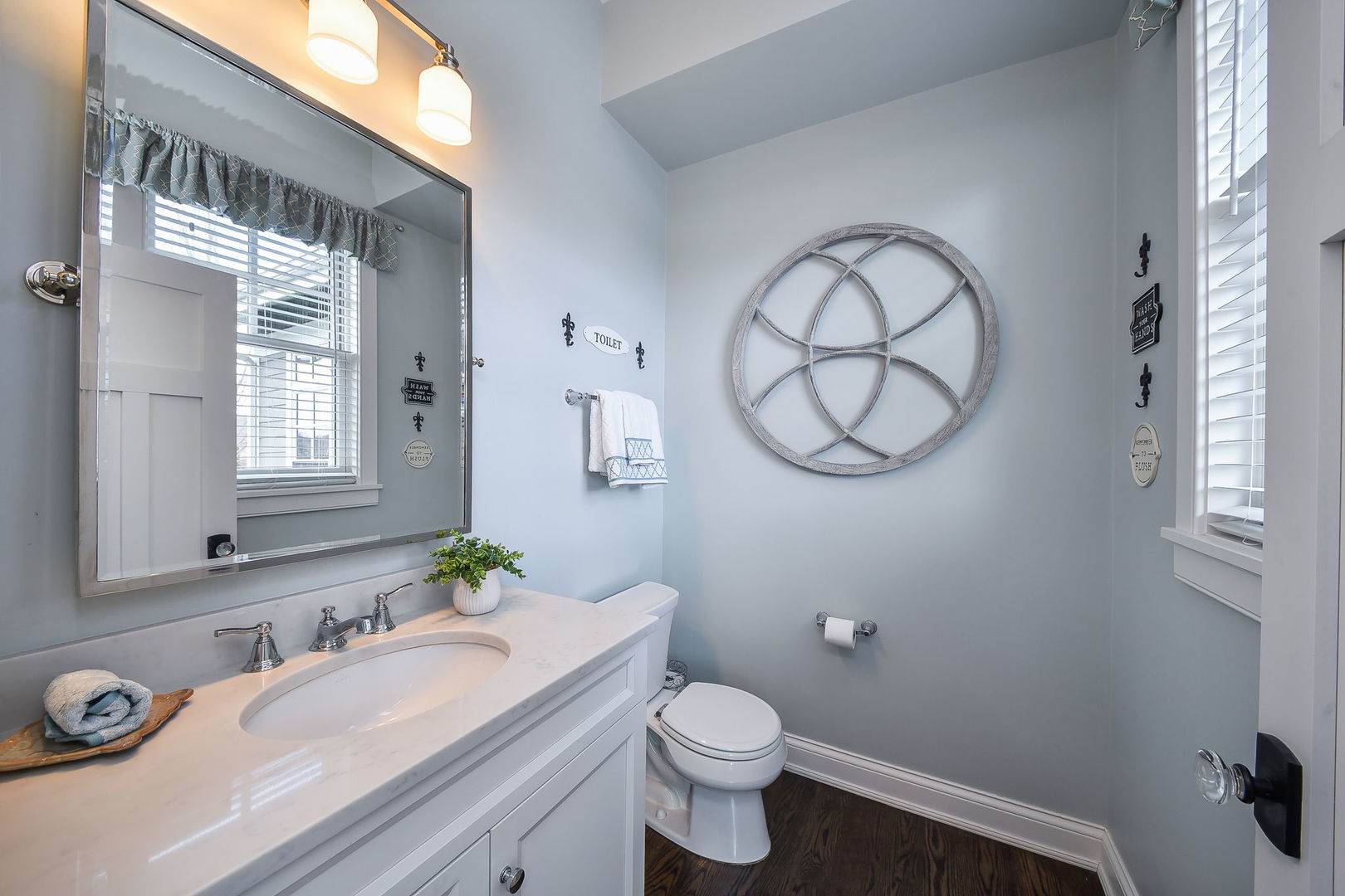 39-w914 Kellar Square Geneva, IL 60134 - Photo 24 of 68 a bathroom with a granite countertop toilet a sink and a mirror