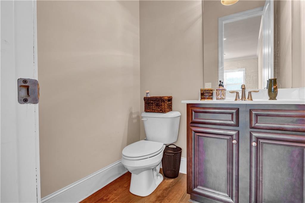 2453 Soft Maple Street Doraville, GA 30360 - Photo 17 of 30 a bathroom with a toilet sink and mirror