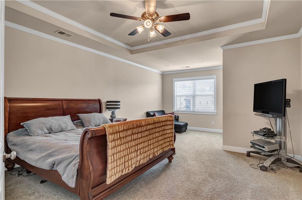 2453 Soft Maple Street Doraville, GA 30360 - Photo 25 of 30 a bedroom with a bed and a flat tv screen on the dresser
