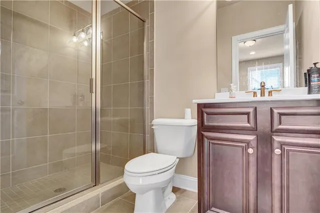 a bathroom with a toilet a sink and shower