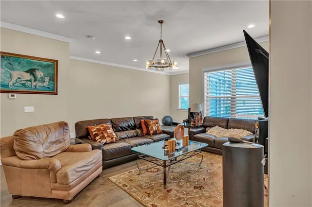 a living room with furniture and a chandelier