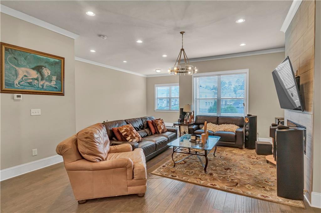 2453 Soft Maple Street Doraville, GA 30360 - Photo 8 of 30 a living room with furniture a chandelier and a flat screen tv