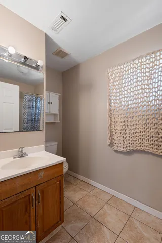 a bathroom with a sink a vanity and a mirror