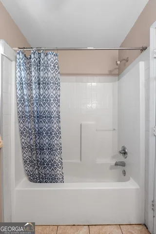 a bathroom with a bathtub and shower