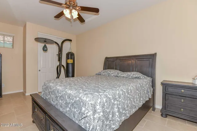 a bedroom with a bed and a dresser