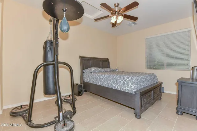 a bedroom with a bed and chandelier