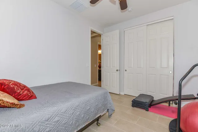 a bedroom with a bed and a lamp