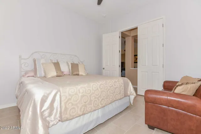 a bedroom with a bed and couch