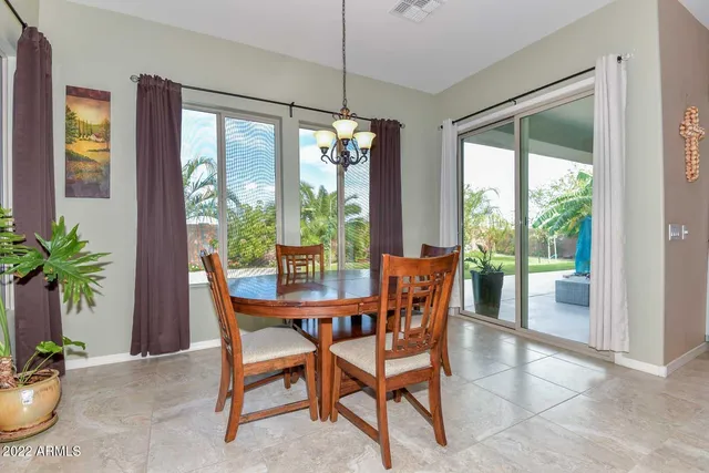 a view of a dining room with furniture large windows and wooden floor