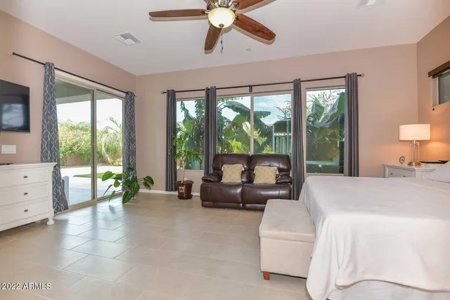 a living room with furniture and large windows