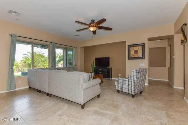 a view of a hallway that has a dining table and chairs