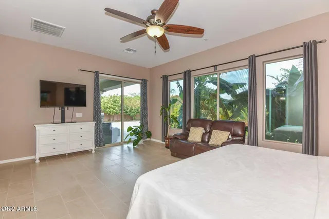 a bedroom with a large bed and a large window with outer view