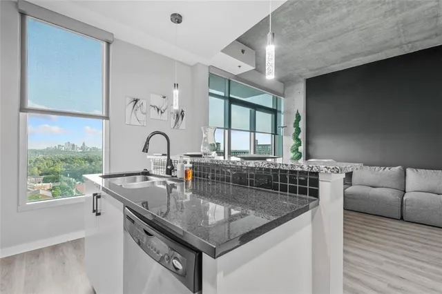 a kitchen with stainless steel appliances kitchen island granite countertop a refrigerator and a stove top oven