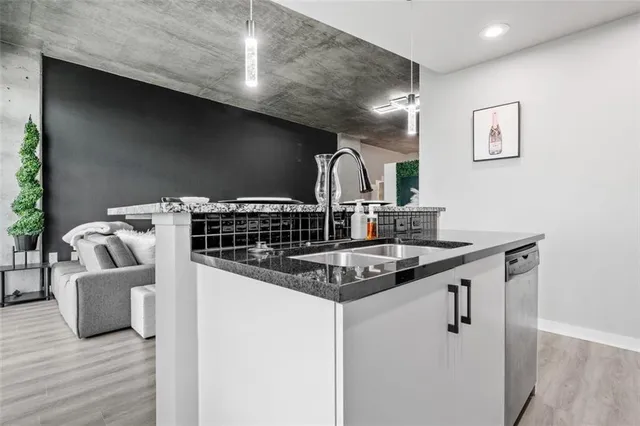 a bathroom with a granite countertop sink toilet mirror and bathtub