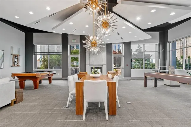 a room with pool table and windows