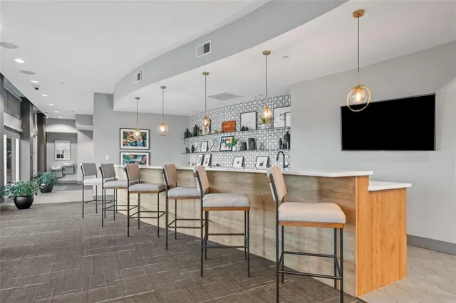 a kitchen with stainless steel appliances granite countertop a sink a refrigerator and a stove with white countertops