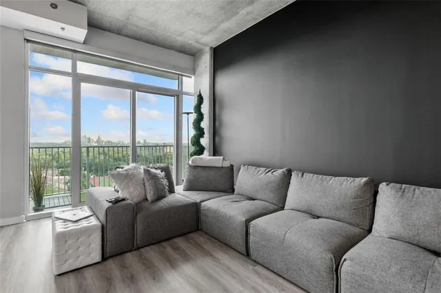 a living room with furniture and a wooden floor