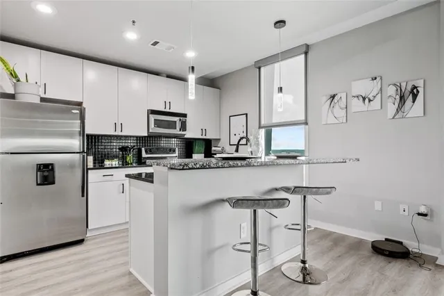 a kitchen with granite countertop a sink and a window