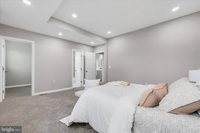 a bedroom with a bed and a night stand