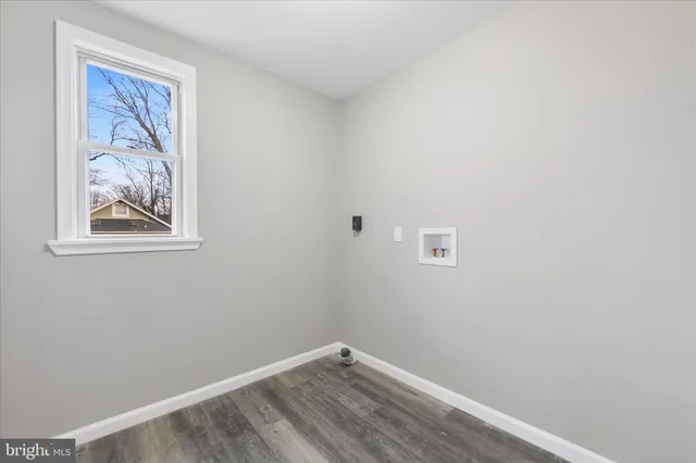 a view of a small space with wooden floor and a window