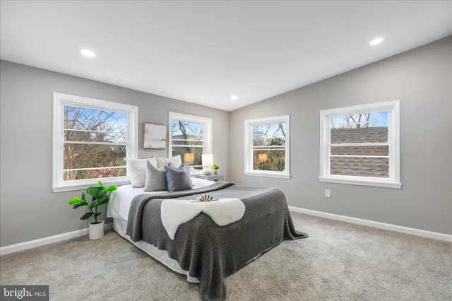 a bedroom with a bed lamp and window