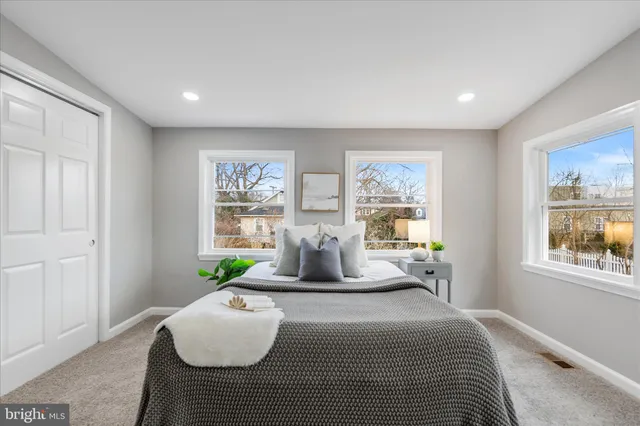 a bedroom with furniture and a large window