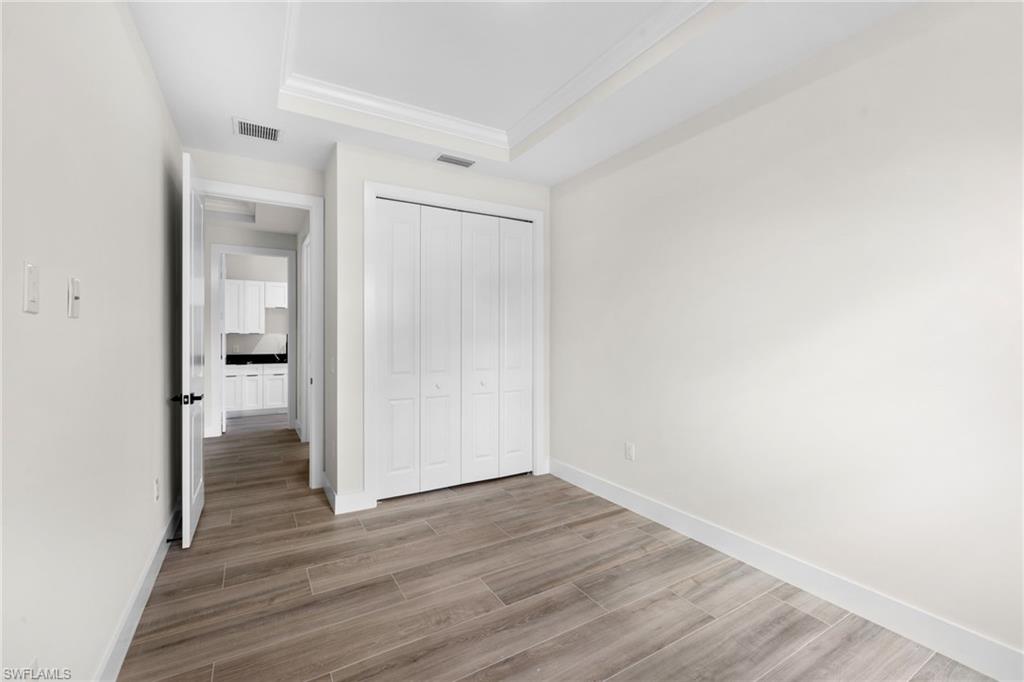 3049 Pine Tree Drive Naples, FL 34112 - Photo 14 of 38 a view of a room with wooden floor