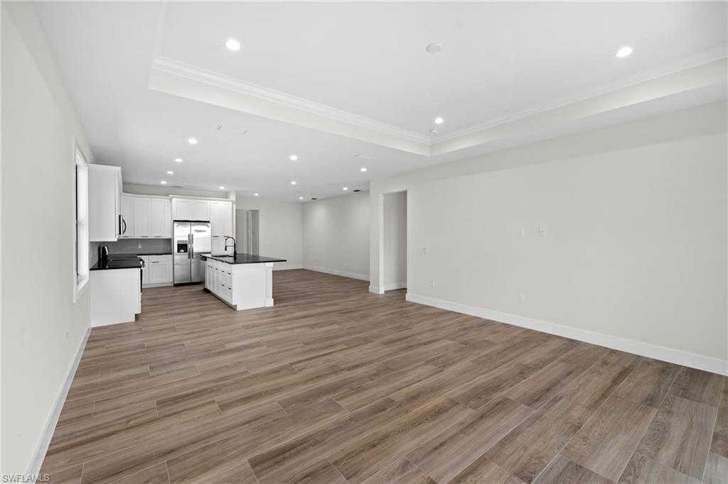 3049 Pine Tree Drive Naples, FL 34112 - Photo 25 of 38 a view of kitchen with kitchen island sink and refrigerator