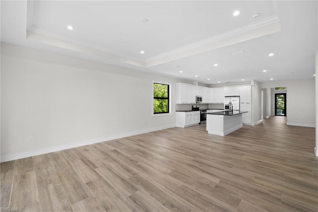 3049 Pine Tree Drive Naples, FL 34112 - Photo 26 of 38 a view of kitchen with cabinets and wooden floor
