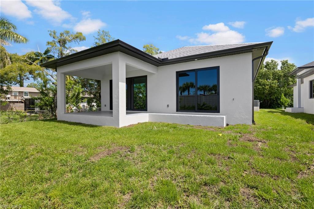 3049 Pine Tree Drive Naples, FL 34112 - Photo 30 of 38 front view of a house with a yard