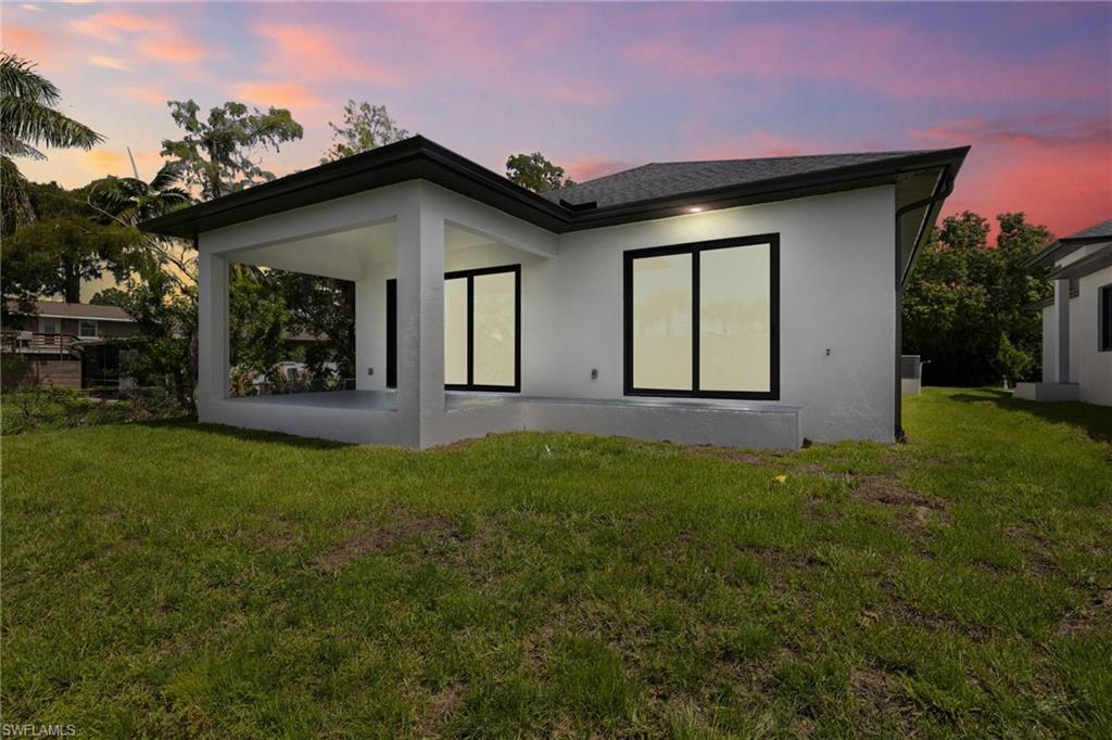3049 Pine Tree Drive Naples, FL 34112 - Photo 31 of 38 a front view of a house with garden