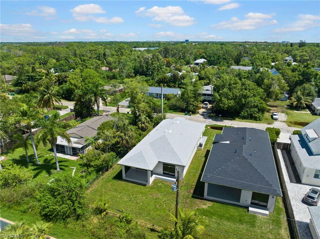 3049 Pine Tree Drive Naples, FL 34112 - Photo 33 of 38 an aerial view of a house with pool patio and outdoor seating