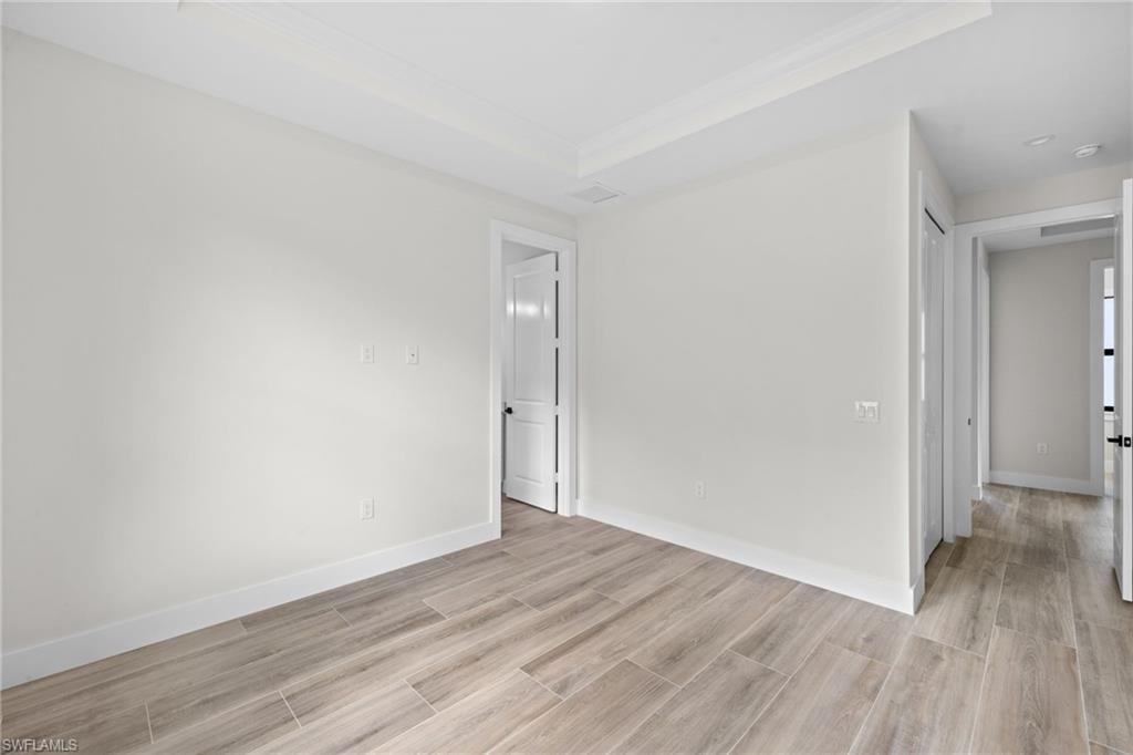 3049 Pine Tree Drive Naples, FL 34112 - Photo 10 of 38 a view of an empty room and wooden floor