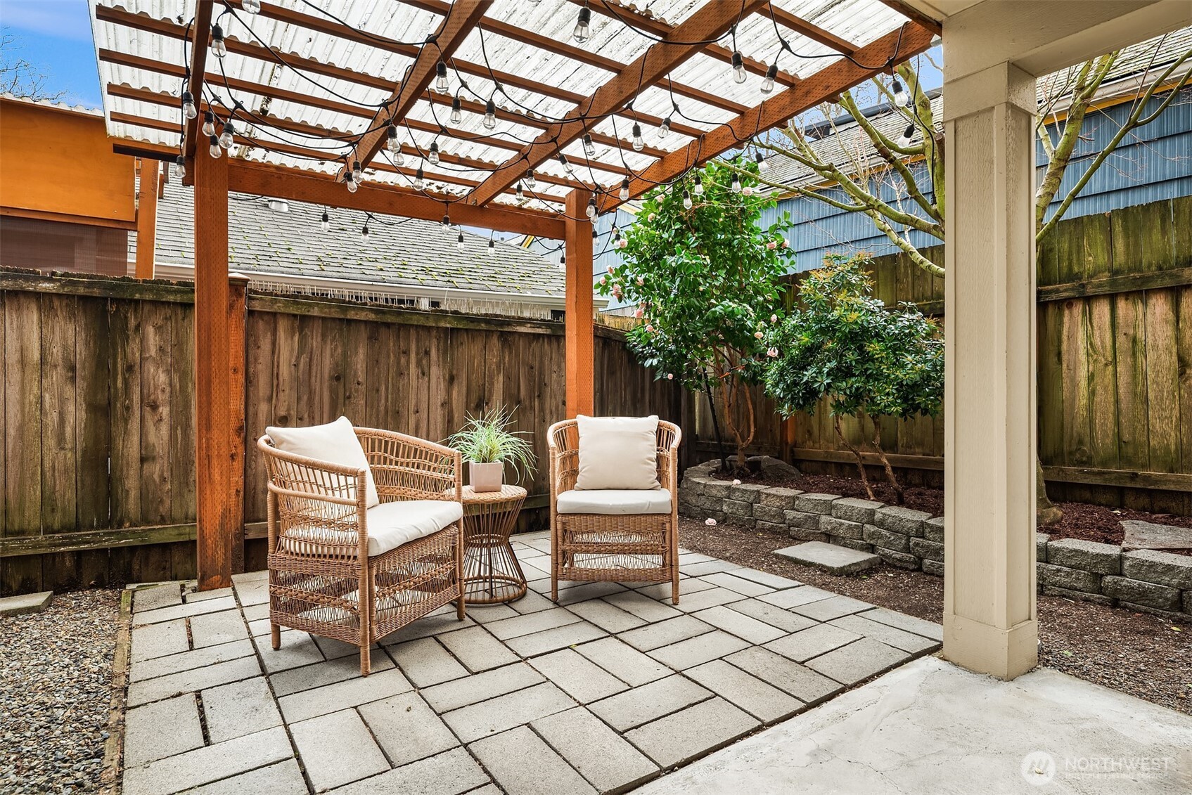 6537 34th Avenue Southwest Seattle, WA 98126 - Photo 15 of 22 a view of a patio with a table and chairs and wooden fence