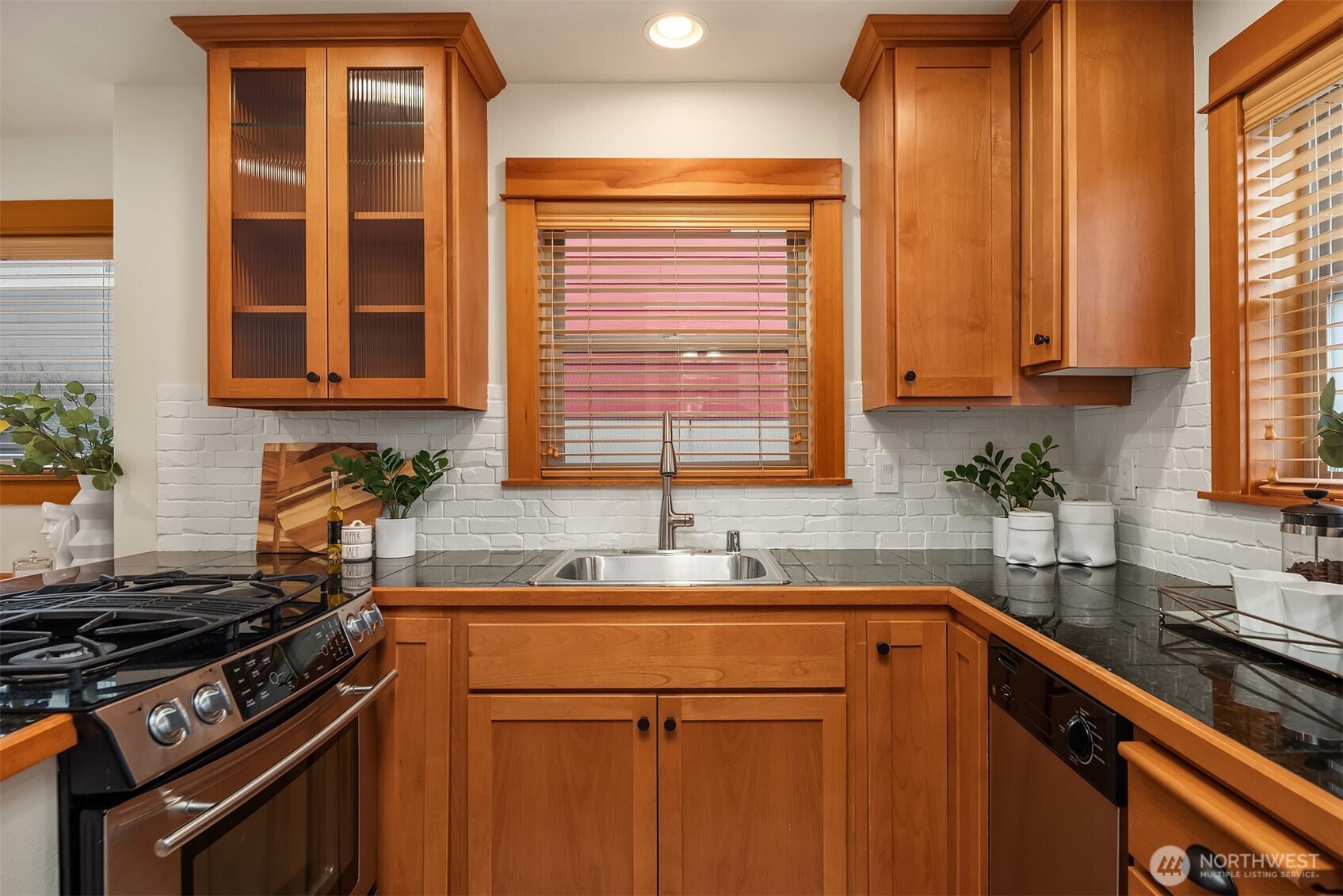 6537 34th Avenue Southwest Seattle, WA 98126 - Photo 5 of 22 a kitchen with a sink stove top oven and cabinets