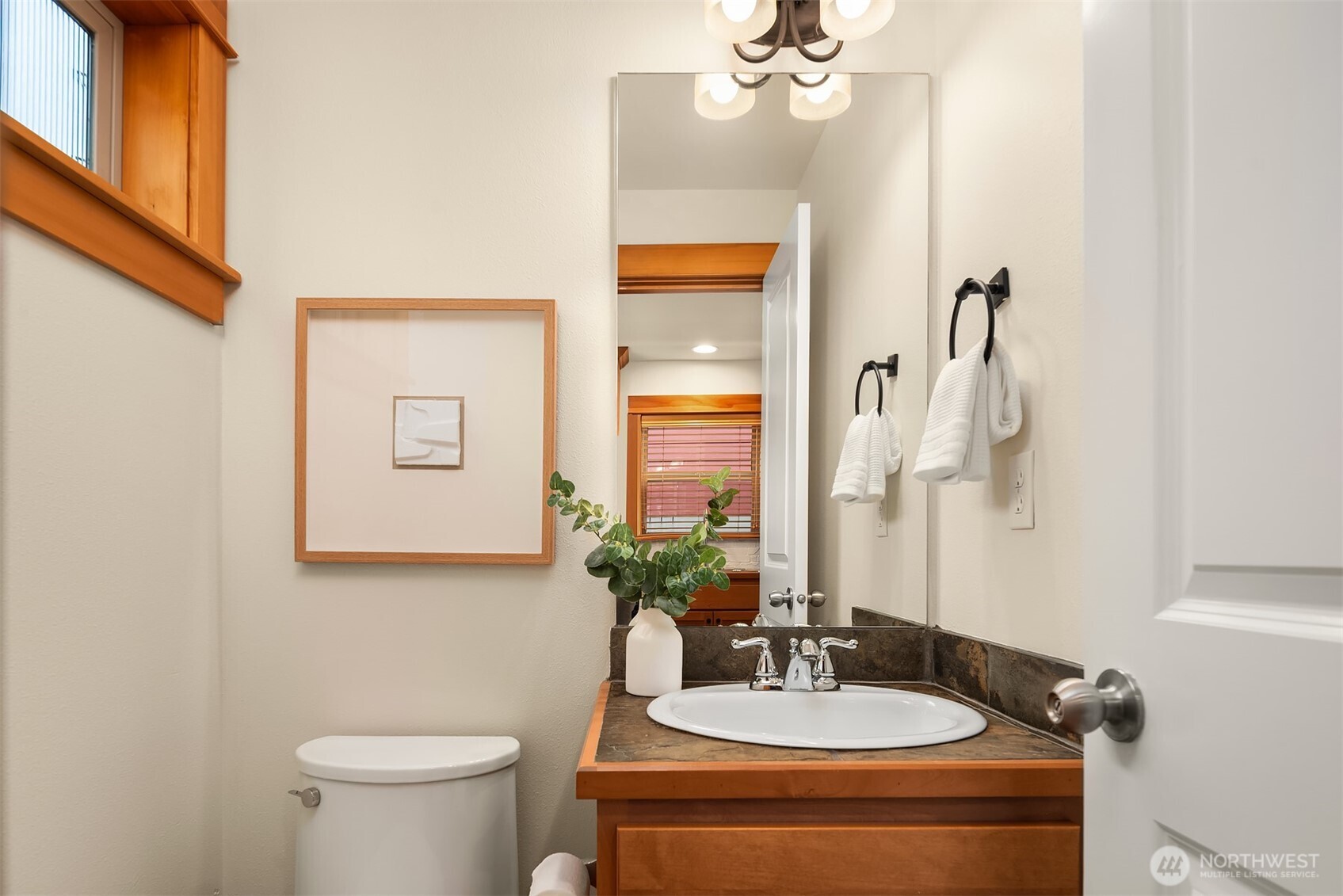 6537 34th Avenue Southwest Seattle, WA 98126 - Photo 7 of 22 a bathroom with a toilet sink and mirror