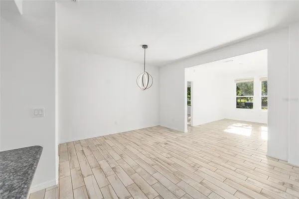 a view of a room with wooden floor and white walls