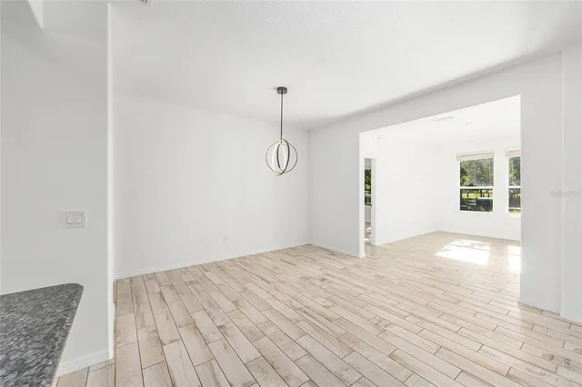 a view of a room with wooden floor and white walls