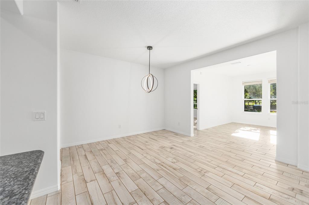 4970 Northwest 35th Ln Road Ocala, FL 34482 - Photo 12 of 41 a view of a room with wooden floor and white walls